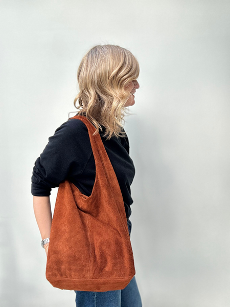 Light chocolate suede slouchy tote bag worn by Cathy