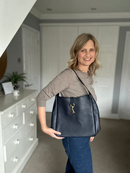 navy Leather womens Shoulder Bag from Alice's Wonders worn by Cathy